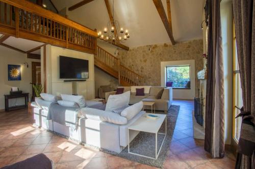 a living room with white couches and a tv at 7 Bedroom Secluded Villa close to Prague in Ricany