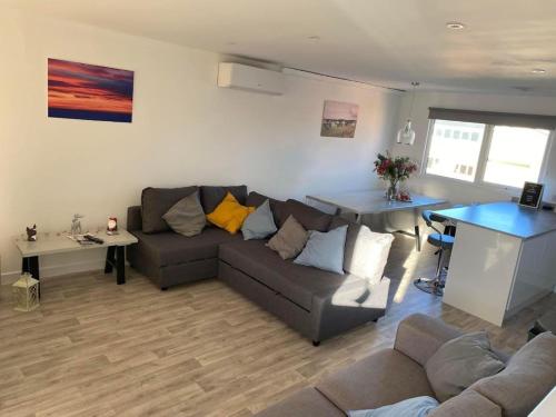 a living room with a couch and a table at Hunny Hideaway, Hunstanton - dog friendly haven by the sea in Hunstanton