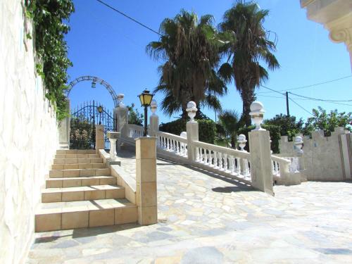 a fence and stairs with a roller coaster in the background at Castellino Studios in Faliraki