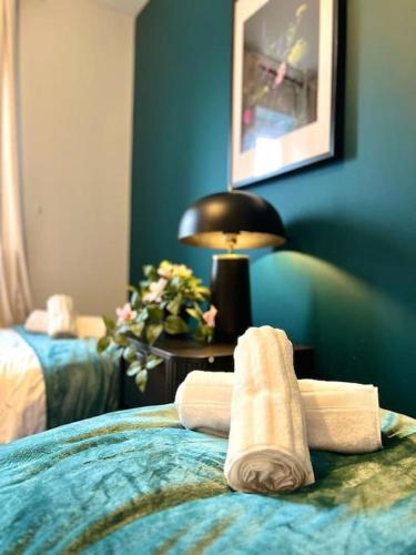 a hotel room with two towels on a bed at Damson Drive- Boutique Home in Oldbury