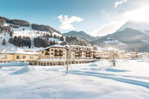 a resort in the mountains covered in snow at ROBINSON AMADÉ in Kleinarl