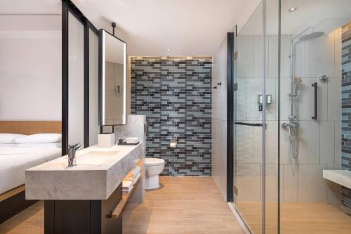 a bathroom with a sink and a toilet and a shower at Fairfield by Marriott Jingzhou in Jingzhou