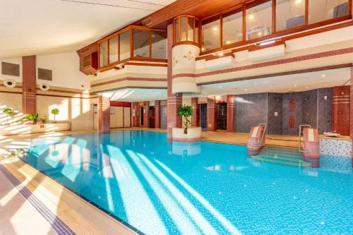 a large swimming pool in a building with a large swimming pool at Whitewater Hotel & Spa in Newby Bridge