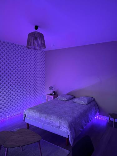 a purple bedroom with a bed and a purple ceiling at Le Madeleine - Cosy & Rénové - Face Tram in Orléans