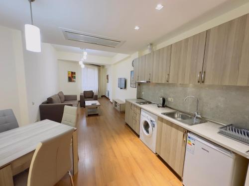 a kitchen and living room with a couch and a table at Apartments by GR Yerevan in the city centre in Yerevan