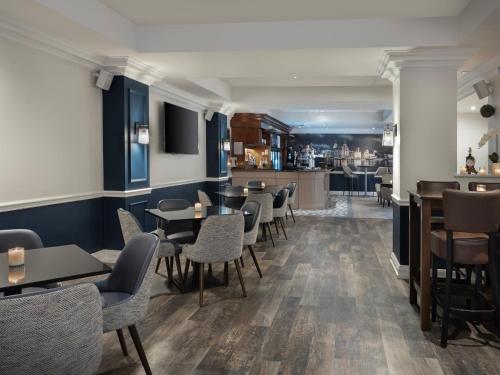 a restaurant with tables and chairs and a bar at Delta Hotels by Marriott Liverpool City Centre in Liverpool
