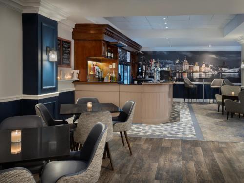 a restaurant with tables and chairs and a bar at Delta Hotels by Marriott Liverpool City Centre in Liverpool