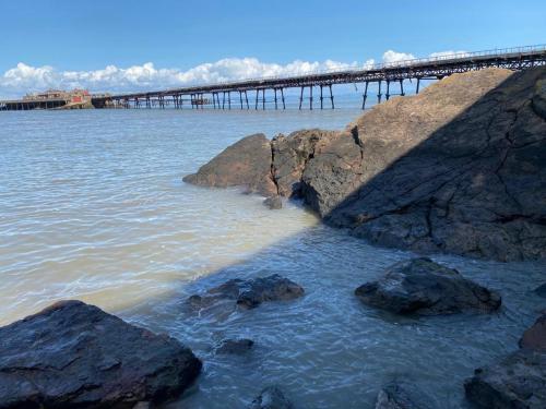 a bridge over a body of water with rocks at The Retreat in Weston-super-Mare