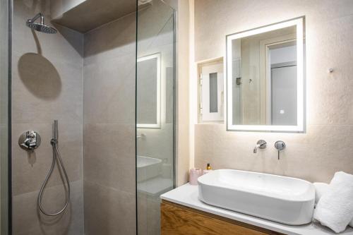 a bathroom with a sink and a glass shower at "Sunbow Jungle" - New Boutique Apt Downtown Athens in Athens