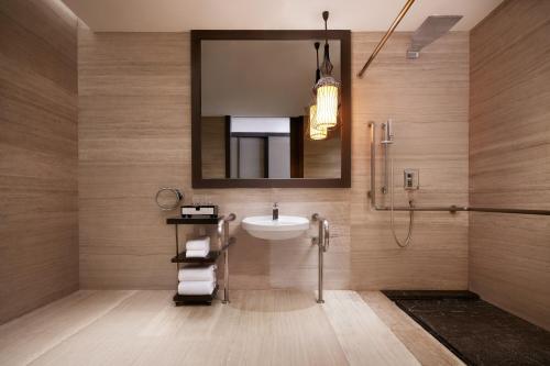 a bathroom with a sink and a mirror at Sheraton Shanghai Waigaoqiao Hotel in Shanghai