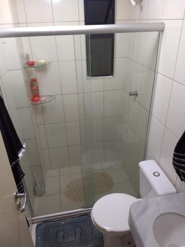 a bathroom with a shower with a toilet and a sink at LAZER NA ATALAIA in Aracaju