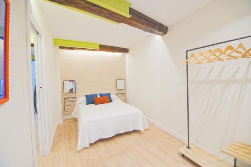 1 dormitorio con 1 cama en una habitación blanca en Ardigales Casco Antiguo, en Castro Urdiales