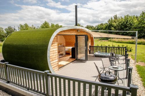 a round house with a green roof on a deck at Woodcock in Selby