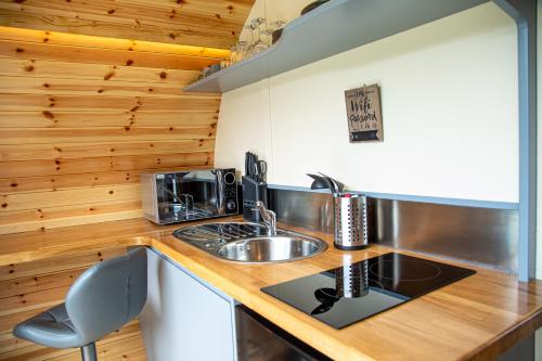 a kitchen with a sink and a stove top oven at Woodcock in Selby