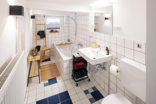 a white bathroom with a sink and a toilet at Ferienhaus Altstadtflair Bad Wildungen - bis 8 Personen in Bad Wildungen