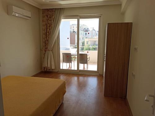 a bedroom with a bed and a large window at Heart of The City + History + Amenities + City Attractions in Antalya