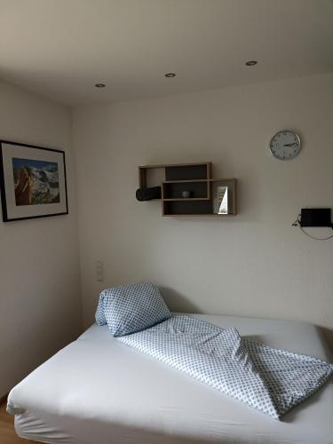a bedroom with a bed and a clock on the wall at Apart ban Voltas in Umhausen