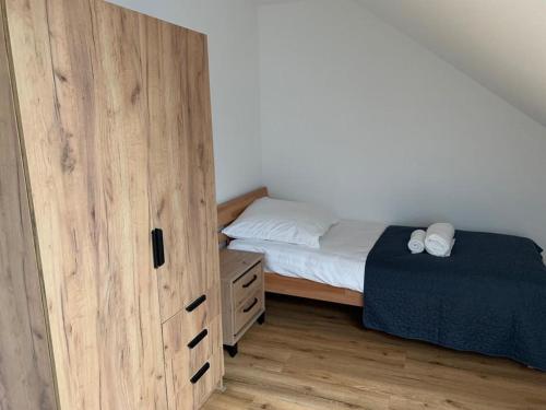 a bedroom with a bed and a large wooden door at Gasthaus Pinneberg in Pinneberg