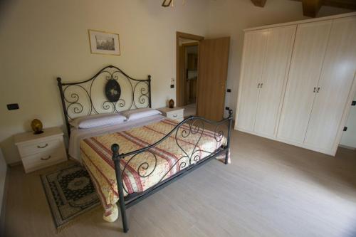 a bedroom with a bed with a metal frame at Villa le Colline - Homelike Villas in Cingoli