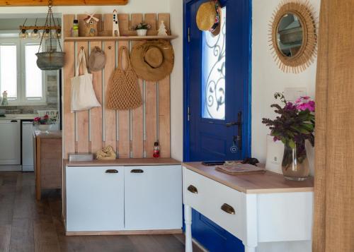 a kitchen with blue and white cabinets and a blue door at Masal Evimiz in Antalya