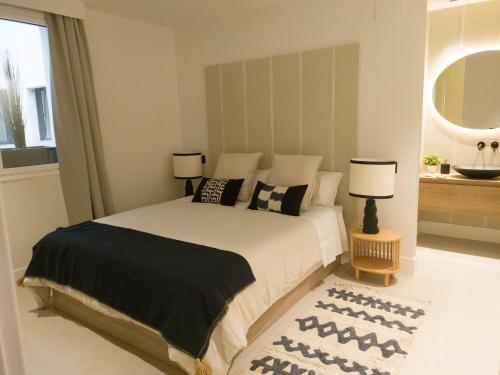 1 dormitorio con 1 cama con 2 lámparas y 1 alfombra en Precioso apartamento nuevo en calle Ferraz, en Madrid