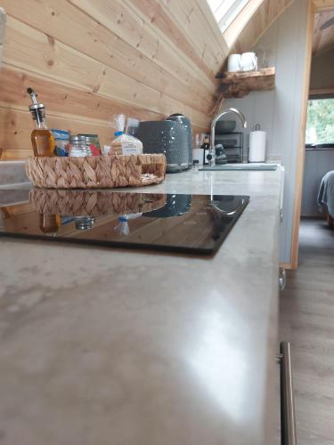 a kitchen with a counter in a tiny house at Eastfield Glamping Farm in Spennithorne