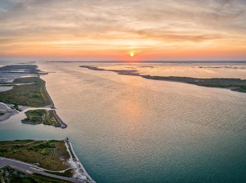 an aerial view of the ocean at sunset at Tranquil Cove in Port Aransas