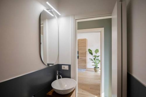 a bathroom with a sink and a mirror at Luxury House Belgrande in Milan