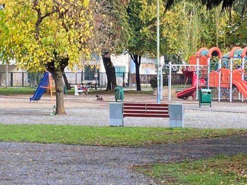 a park with a bench and a playground at Departamento Zurich en Temuco in Temuco