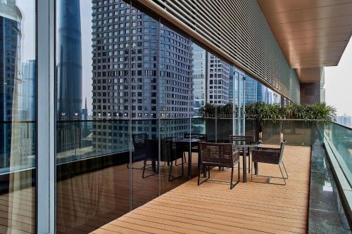 - un balcon avec une table et des chaises dans un bâtiment dans l'établissement W Guangzhou, à Canton