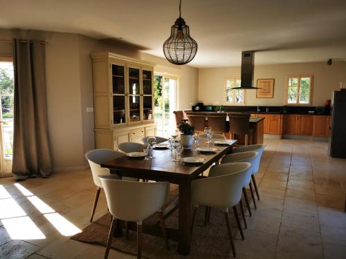 une salle à manger avec une table et des chaises en bois dans l'établissement Comtesse Mahaut - Gîte de Charme - Les Bastides d'Edouard en Bourgogne, à Mailly-le-Château