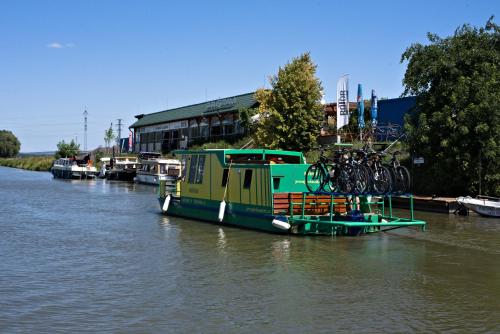 a boat with bikes on it on a river at New Pension at ROTOR Brewery in Kunovice