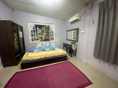 Katil atau katil-katil dalam bilik di Homestay Bukit Awi