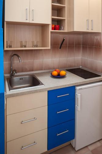 a kitchen with a sink and a bowl of oranges at Kornelija 2 in Podgora