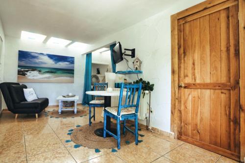 Zimmer mit einem Tisch, Stühlen und einer Tür in der Unterkunft Finca Vino Tinto 4 in Icod de los Vinos