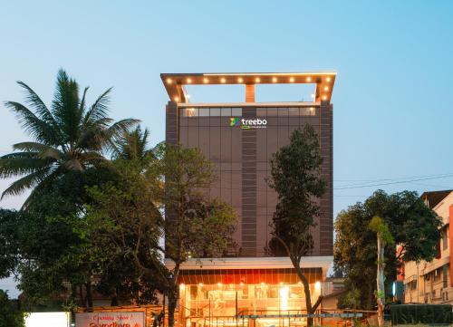 a building with lights on top of it at Treebo Trend Lemon Wood Suites in Pune