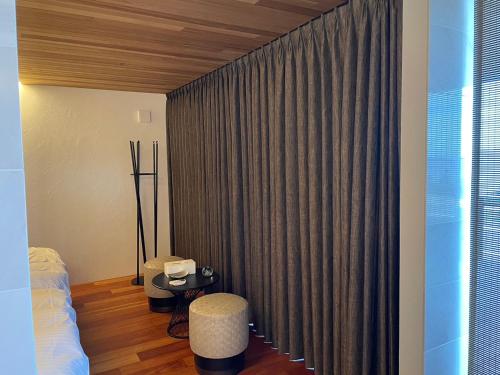 a bedroom with a bed and a window with curtains at Soukyu 蒼穹 #TB1 in Yonago