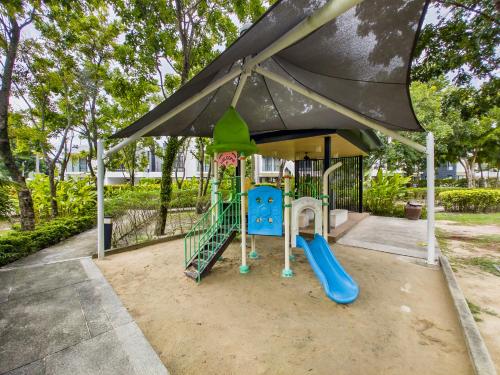 a playground with a slide and an umbrella at Townhouse in Laguna Park in Phuket Town