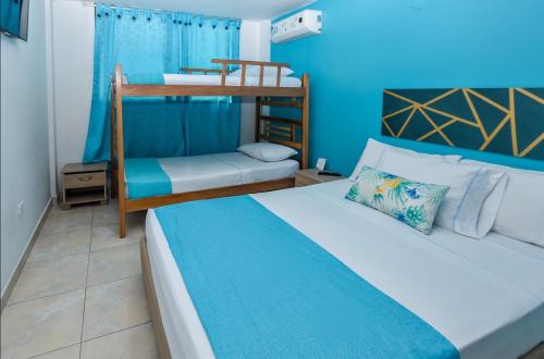 1 dormitorio con 2 camas y 1 litera en Taybo Beach By St Hoteles, en Santa Marta