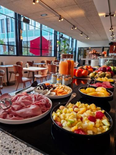 a buffet with many plates of food on a table at Le Grand Quartier in Paris