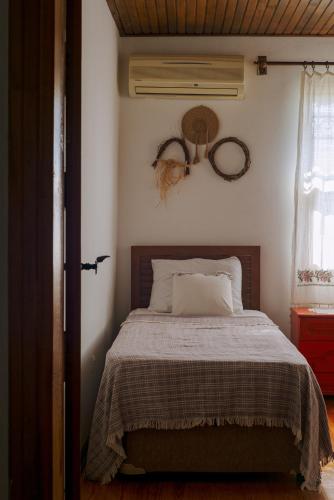a bedroom with a bed with a blanket and a window at Masal Evimiz in Antalya
