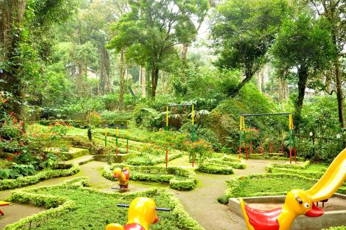 a garden with a playground with toy animals in it at The Tall Trees in Munnar