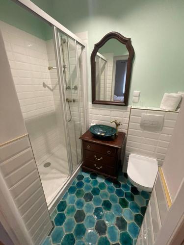 a bathroom with a shower and a sink and a mirror at Ratuszowa 13 in Prudnik