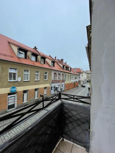 a view of a street from a balcony of a building at Ratuszowa 13 in Prudnik