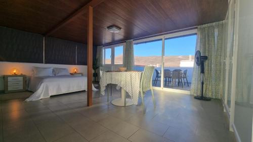 a bedroom with a bed and a table with a view at Tarajalejo Eco C in Tarajalejo