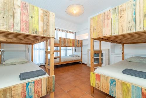 a room with two bunk beds in a house at Ticket2Surf in Palheiros da Tocha