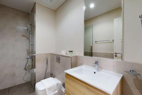 a bathroom with a sink and a toilet and a shower at Key View - Golf Vita in Dubai Marina