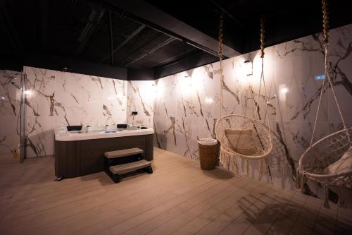 a bathroom with a sink and two baskets and lights at Le Drip's in Marseille