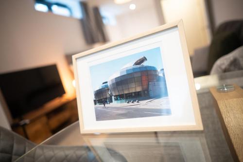 a picture of a building on a glass table at 123 Queen Street - Home Crowd Luxury Apartments in Sheffield