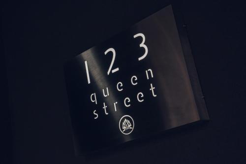 a clock with the time on it with the number thirteen at 123 Queen Street - Home Crowd Luxury Apartments in Sheffield